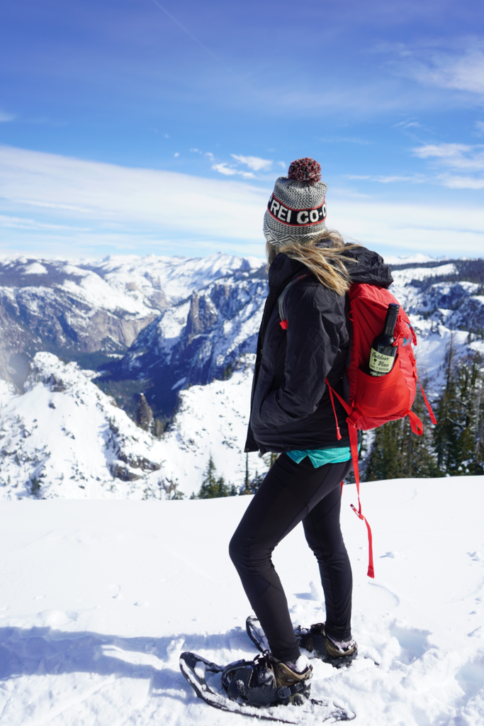 Gazing out at Dewey Point at Yosemite National Park after snowshoeing in, ready to enjoy a  bottle of Outdoor Vino.