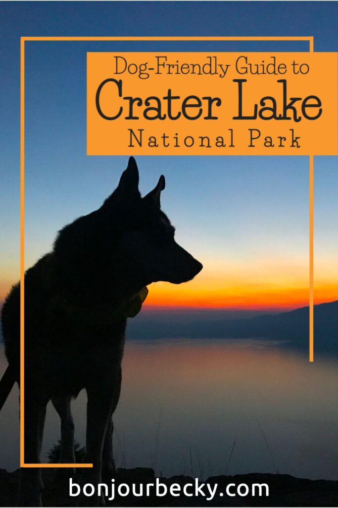 Photo of a dog in front of a sunset at Crater Lake National Park. Text overlay reads "Dog-friendly guide to Crater Lake National Park." Learn more at bonjourbecky.com.